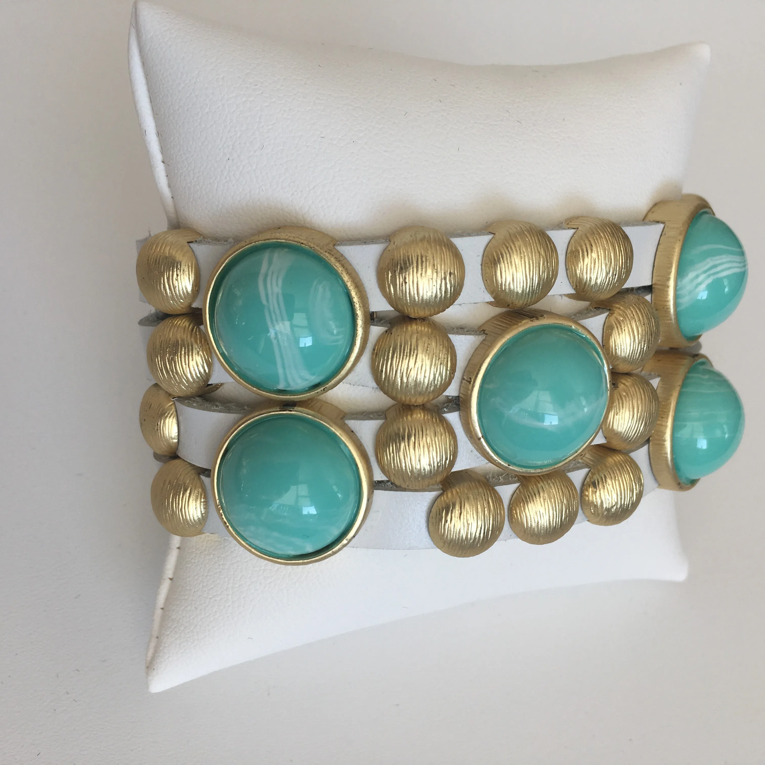 Bursting Goldtone Beads and Turquoise Resin Accents Adorn this White Leather Bracelet with Magnetic Clasp